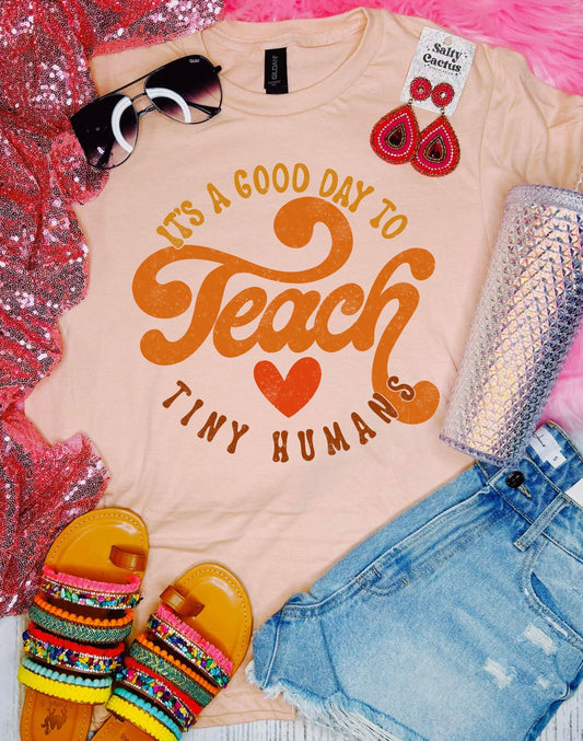 Retro Teach Tiny Humans Peach Tee